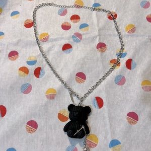 Black teddy bear with a mace chain necklace